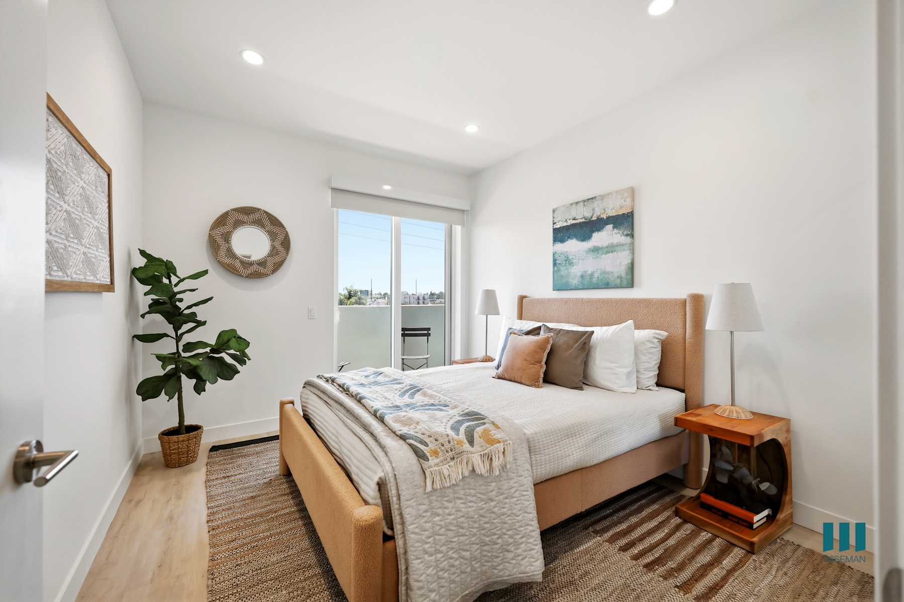Bright living room with a green sofa and large window
